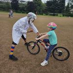 Professor Balance, teaching a child to ride a bike