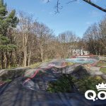 Picture shows a pump track set among trees