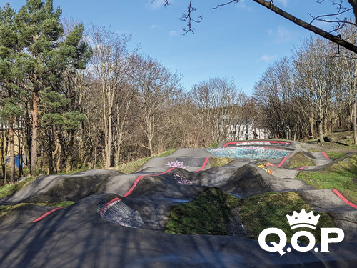Picture shows a pump track set among trees